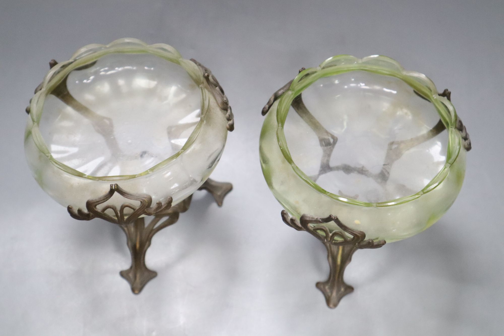 A pair of Art Nouveau vaseline glass dishes, on bronze stands, height 12cm
